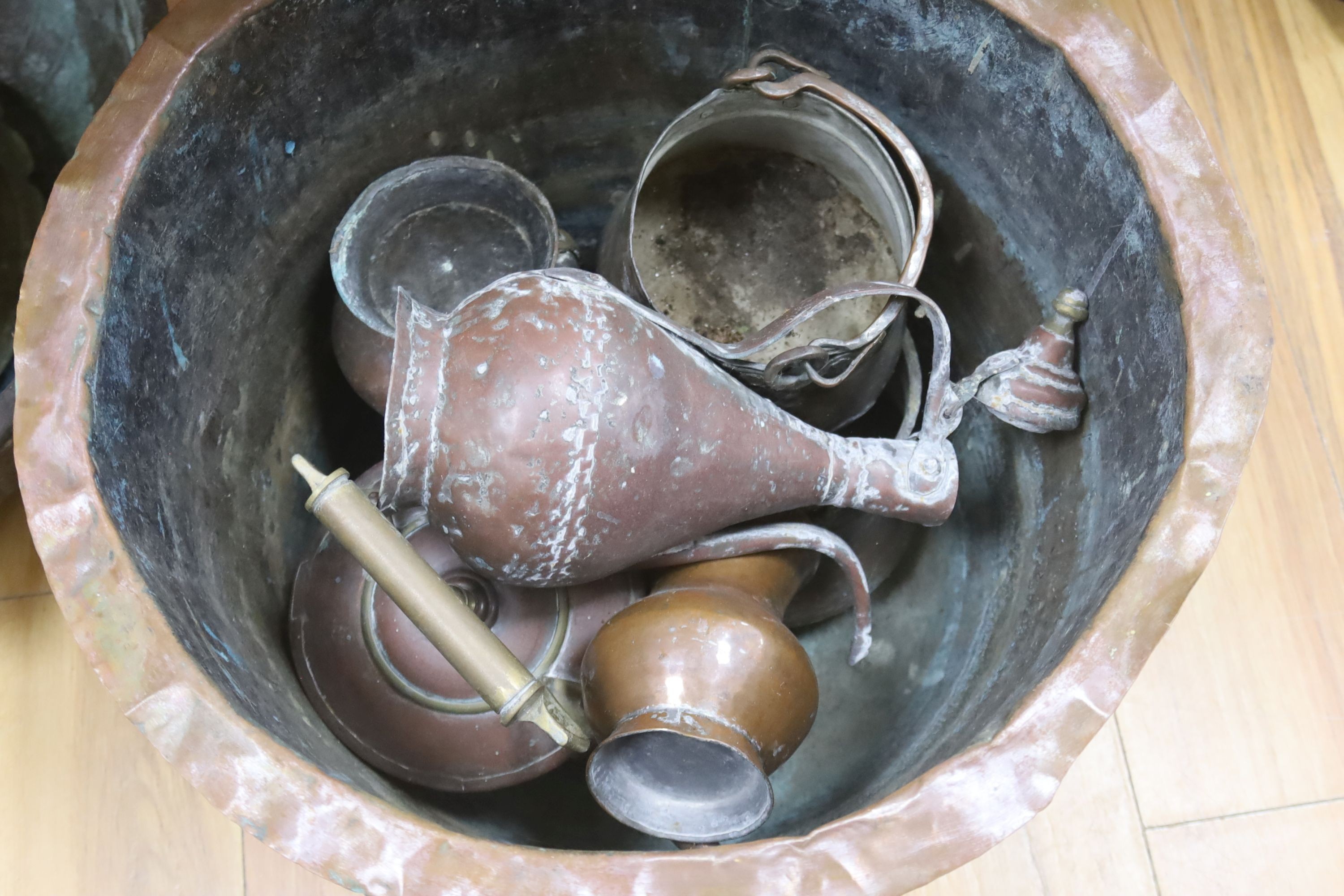 Two large copper bowls and related items, largest 54 cms diameter.